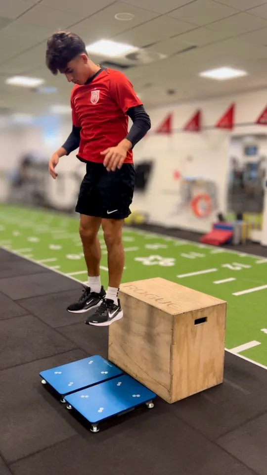 Athlete performing a drop-jump test onto force plates